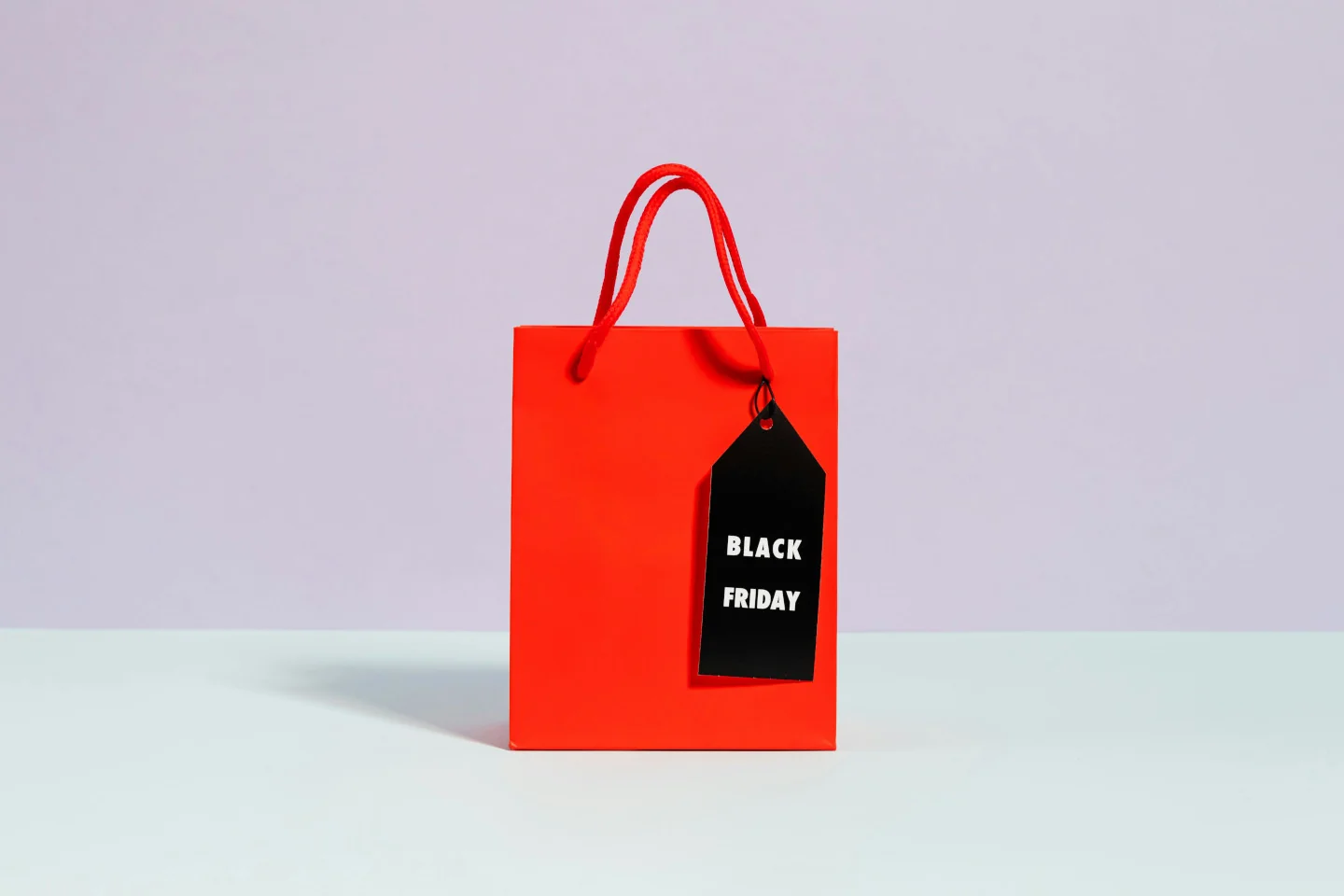 A red gift bag with a black and white Black Friday label
